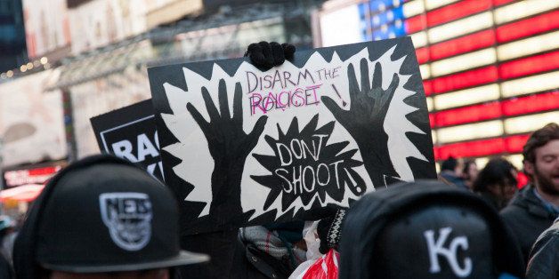 Demonstration against no indictment of Darren Wilson, policeman who murderd Mike Brown in Ferguson, Mo. Demonstration in New York on Friday November 28, 2014 "Black Lives Matter Friday" in New York City. Times Squars, Harold Square. Macys, the "Don't Shoot" sign is made and carried by the artist Jenny Polak