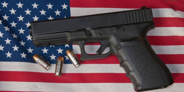 Pistol and ammunition on top of an American flag.