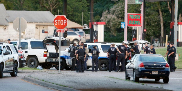 Police block the intersection of Dowdy Ferry Rd and Interstate 45 during a stand off with a gunman barricaded inside a van, Saturday, June 13, 2015, in Hutchins, Texas. The gunman allegedly attacked Dallas Police Headquarters. (AP Photo/Brandon Wade)