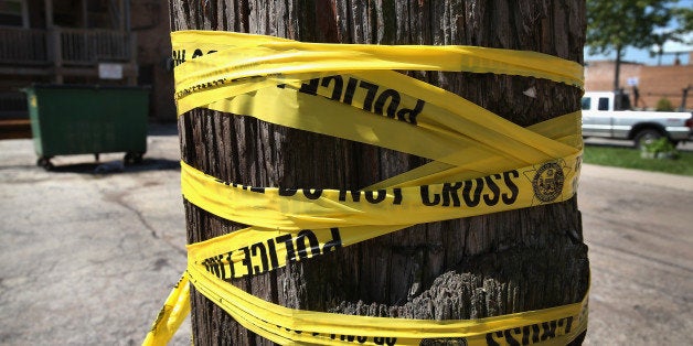 CHICAGO, IL - MAY 13: Crime scene tape is wrapped around a power pole near the location where a 20-year-old man died from a gunshot wound to the head and a 15-year-old boy was shot and wounded during weekend violence on May 13, 2013 in Chicago, Illinois. Three people were shot and killed and at least six others were wounded in gun violence in the city this past weekend. Chicago Police Superintendent Garry McCarthy held a press conference today to announce his department had seized more than 2,500 illegal firearms in the city so far this year. (Photo by Scott Olson/Getty Images)