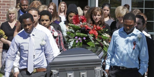 Pallbearers carry the casket of Darrien Hunt following funeral services Thursday, Sept. 18, 2014, in Saratoga Springs, Utah.