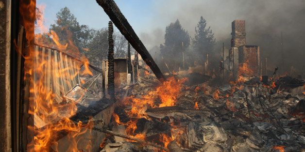 SAN MARCOS, CA - MAY 15: A house burns at the Cocos fire on May 15, 2014 in San Marcos, California. Fire agencies throughout the state are scrambling to prepare for what is expected to be a dangerous year of wildfires in this third year of extreme drought in California. (Photo by David McNew/Getty Images)