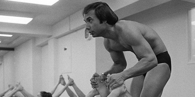 BEVERLY HILLS - 1982: Founder and teacher of Bikram Yoga, Bikram Choudhury assists actress Carol Lynley with the 'Bow Pose' a