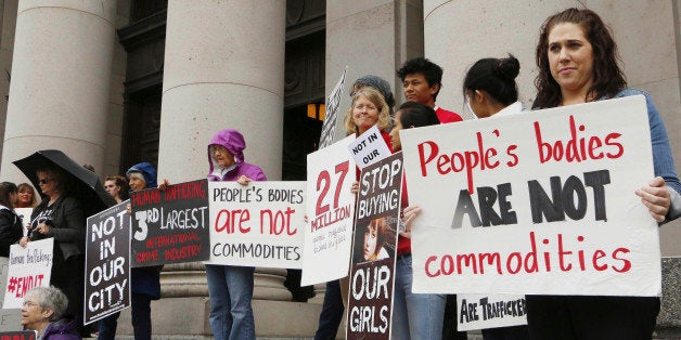 FILE - In this Oct. 21, 2014 file photo, people opposed to child sex trafficking rally outside of the Washington state Supre