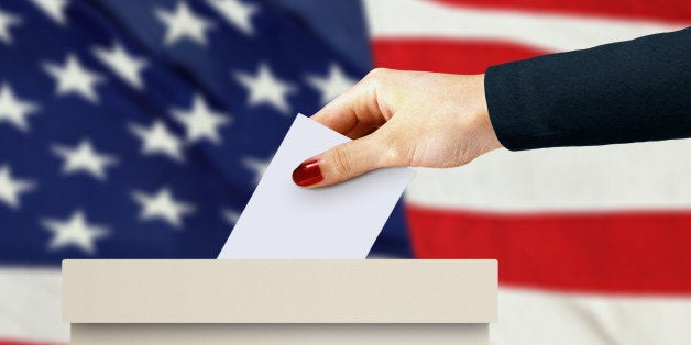 women hand casting a vote