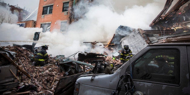 NEW YORK, NY - MARCH 12: Heavy smoke pours from the debris as the Fire Department of New York (FDNY) responds to a 5-alarm fire and building collapse at 1646 Park Ave in the Harlem neighborhood of Manhattan March 12, 2014 in New York City. Reports of an explosion were heard before the collapse of two multiple-dwelling buildings that left at least 11 injured. (Photo by Andrew Burton/Getty Images)