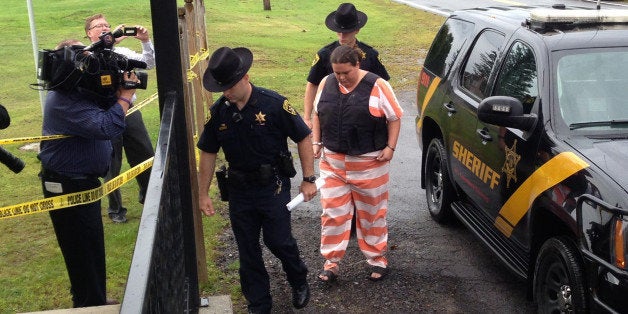 Lawrence County sheriffᅢ까タᅡルs deputies escort Nicole Vaisey to her preliminary hearing Thursday, Aug. 21, 2014, at town cour