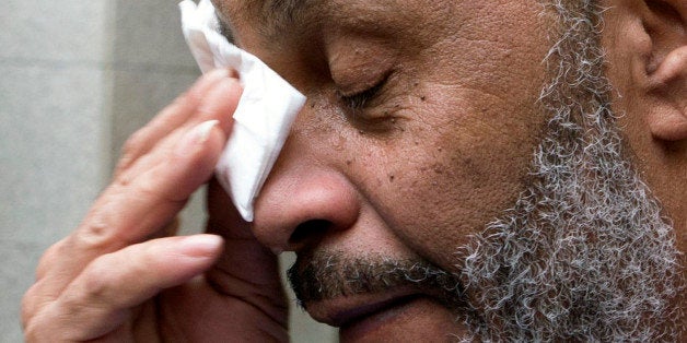 Anthony Ray Hinton wipes away tears after greeting friends and relatives upon leaving the Jefferson County jail, Friday, April 3, 2015, in Birmingham, Ala. Hinton spent nearly 30 years on Alabama's death row, and was set free Friday after prosecutors told a judge they won't re-try him for the 1985 slayings of two fast-food managers. (AP Photo/ Hal Yeager)