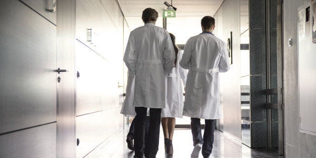 team of doctors walking in hospital hallway