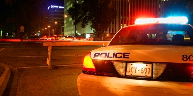 A police car on duty during the night.