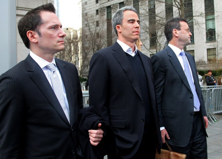 NEW YORK - MARCH 29: SAC Capital portfolio manager Michael Steinberg (C) walks with his lawyers as he leaves federal court a
