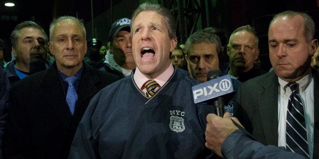 ADDS BOTH OFFICERS KILLED - Patrick Lynch, head of the Patrolmen's Benevolent Association, speaks during a news conference after the bodies of two fallen NYPD police officers were transported from Woodhull Medical Center, Saturday, Dec. 20, 2014, in New York. An armed man walked up to two New York Police Department officers sitting inside a patrol car and opened fire Saturday afternoon, killing both officers before running into a nearby subway station and committing suicide, police said. (AP Photo/John Minchillo)