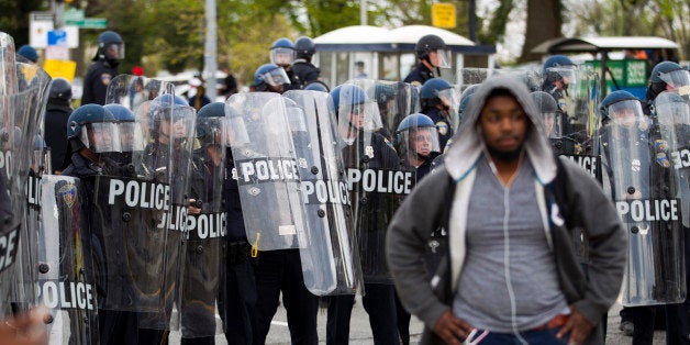 Baltimore police officers push back demonstrators after the funeral of Freddie Gray, Monday, April 27, 2015, in Baltimore. Gray died from spinal injuries about a week after he was arrested and transported in a Baltimore Police Department van. (AP Photo/Jose Luis Magana)