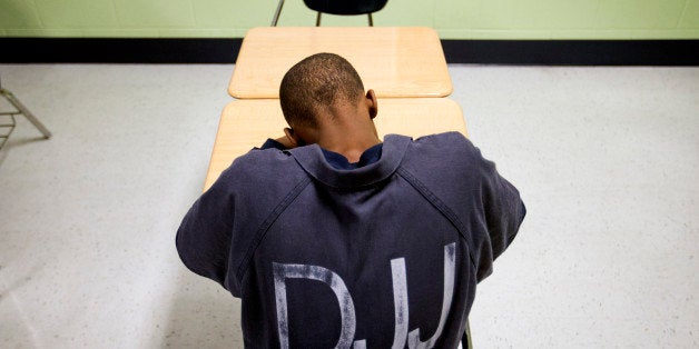 A juvenile resident sits in a classroom at the Department of Juvenile Justice's Metro Regional Youth Detention Center, Wednesday, Aug. 20, 2014, in Atlanta. (AP Photo/David Goldman)