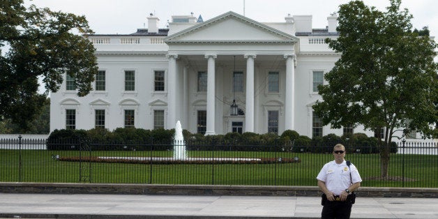 A US Secret Service Uniform Division Officer secures Pennsylvania Avenue which was closed off to pedestrians when the White House went on 'lock-down' mode after gunshots broke out at the US Capitol October 3, 2013. AFP Photo/Paul J. Richards (Photo credit should read PAUL J. RICHARDS/AFP/Getty Images)