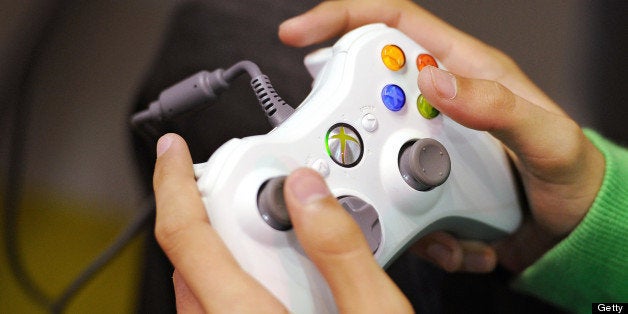 A woman plays with an XBOX games console on October 27, 2010 in Paris during the first edition of the 'Paris Games week' event to be held until October 31, 2010. AFP PHOTO FRANCK FIFE (Photo credit should read FRANCK FIFE/AFP/Getty Images)