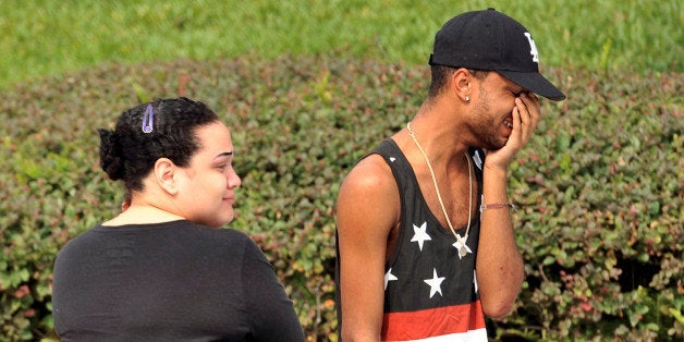 Friends and family members embrace outside the Orlando Police Headquarters during the investigation of a shooting at the Pulse nightclub, where people were killed by a gunman, in Orlando, Florida, U.S June 12, 2016. REUTERS/Steve Nesius