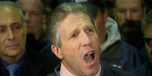 Patrick Lynch, head of the Patrolmen's Benevolent Association, speaks during a news conference after the bodies of two fallen NYPD police officers were transported from Woodhull Medical Center, Saturday, Dec. 20, 2014, in New York. An armed man walked up to two New York Police Department officers sitting inside a patrol car and opened fire Saturday afternoon, killing one and critically wounding a second before running into a nearby subway station and committing suicide, police said. (AP Photo/John Minchillo)