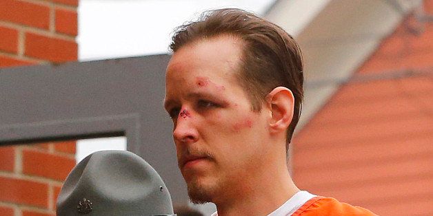 Eric Frein is escorted by police into the Pike County Courthouse for his arraignment in Milford, Pa., Friday Oct. 31, 2014. Frein, was captured seven weeks after police say he killed a Pennsylvania State trooper in an ambush outside a barracks in northeastern Pennsylvania. (AP Photo/Rich Schultz)