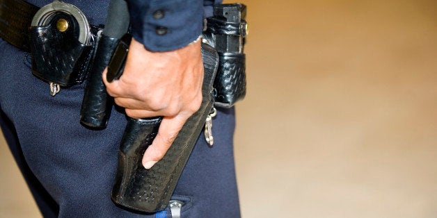 Policeman's hand on gun