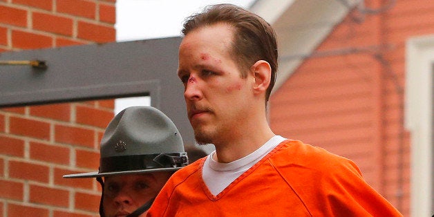 Eric Frein is escorted by police into the Pike County Courthouse for his arraignment in Milford, Pa., Friday Oct. 31, 2014. Frein, was captured seven weeks after police say he killed a Pennsylvania State trooper in an ambush outside a barracks in northeastern Pennsylvania. (AP Photo/Rich Schultz)