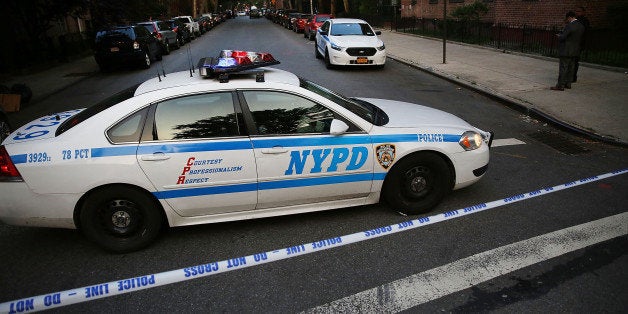 NEW YORK, NY - JUNE 10: A police car is parked at a crime scene where three people were shot on June 10, 2015 in the Gowanus