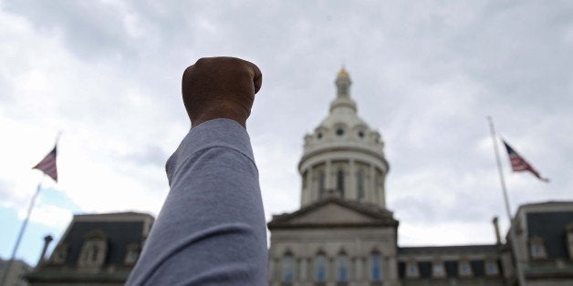 BALTIMORE, MD - MAY 02: Protesters congregate at City Hall a day after Baltimore authorities released a report on the death of Freddie Gray on May 2, 2015 in Baltimore, Maryland. Marilyn Mosby, Baltimore City state's attorney, ruled the death of Freddie Gray a homicide and that criminal charges will be filed on six Baltimore City Police officers. Gray, 25, was arrested for possessing a switch blade knife April 12 outside the Gilmor Houses housing project on Baltimore's west side. According to his attorney, Gray died a week later in the hospital from a severe spinal cord injury he received while in police custody. (Photo by Patrick Smith/Getty Images)