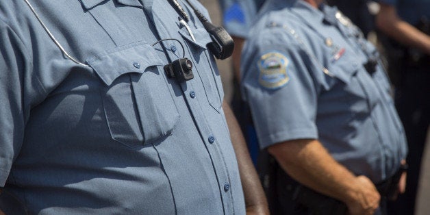 FERGUSON, MO - AUGUST 30: Members of the Ferguson Police department wear body cameras during a rally August 30, 2014 in Fergu