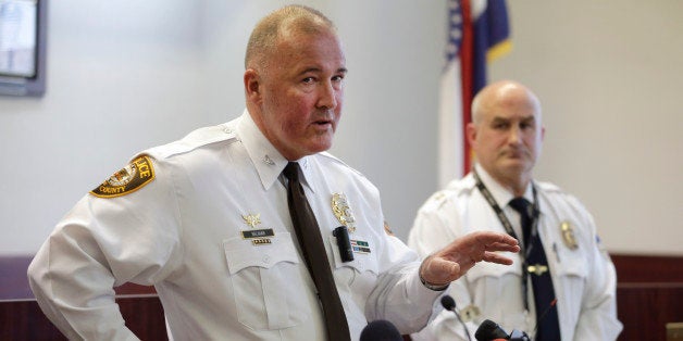 St. Louis County police Chief Jon Belmar, left, answers questions as Webster Groves police Captain Mike Nelson listens during