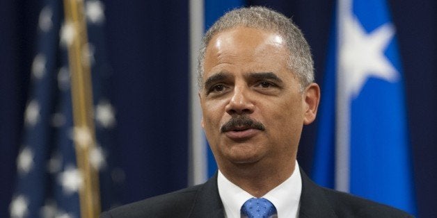 Attorney General Eric Holder speaks during a farewell ceremony in honor of outgoing Federal Bureau of Investigation (FBI) Director Robert Mueller at the Department of Justice on August 1, 2013. Mueller is retiring from the FBI after 12-years as Director. AFP PHOTO / Saul LOEB (Photo credit should read SAUL LOEB/AFP/Getty Images)