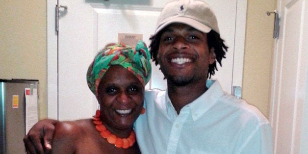 FILE - This undated file photo provided by the family of John Crawford III shows Crawford, right, with his mother, Tressa Sherrod. The family of Crawford, a black man fatally shot by a white police officer as he held an air rifle inside a Wal-Mart filed a federal lawsuit Tuesday, Dec. 16, 2014, charging negligence and violation of the man's civil rights. The lawsuit was filed in U.S. District Court against the Ohio city of Beavercreek, the two Beavercreek officers involved, the police chief and Wal-Mart Stores Inc. (AP Photo/Courtesy family of John Crawford III, File)