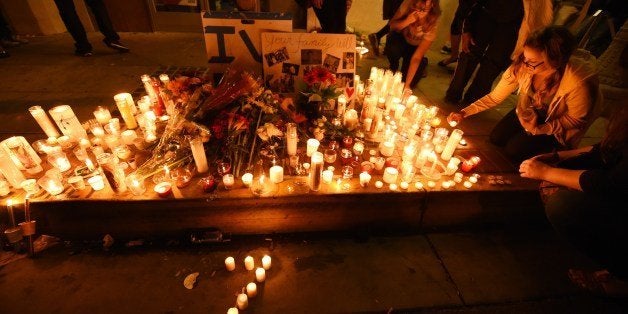 Candles in the shape of a number '7' for the seven dead - six victims and the shooter - in a killing rampage May 24, 2014 are seen at a makeshift memorial in Santa Barbara May 24, 2014. Authorities said the 22-year-old lone gunman, Elliot Rodger the son of a director who worked on the 'The Hunger Games' killed six people. Rodger also died in the attack. AFP PHOTO / ROBYN BECK (Photo credit should read ROBYN BECK/AFP/Getty Images)