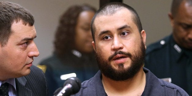 George Zimmerman, the acquitted shooter in the death of Trayvon Martin, answers questions from a Seminole circuit judge, Tuesday, Nov. 19, 2013, in Sanford, Fla., during a first-appearance hearing on charges including aggravated assault stemming from a fight with his girlfriend. Listening, at left, is defense counsel Daniel Megaro. (Joe Burbank/Orlando Sentinel/MCT via Getty Images)