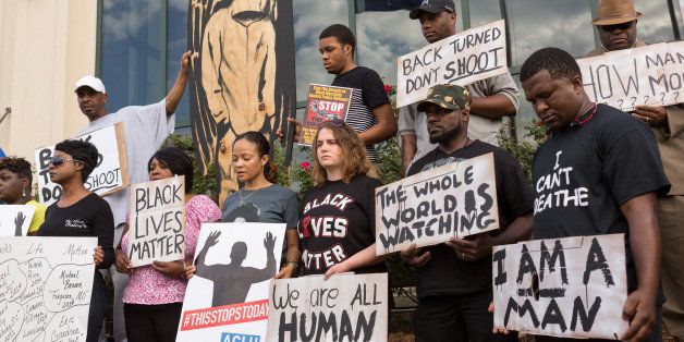NORTH CHARLESTON, SC - APRIL 08: People participate in a rally to protest the death of Walter Scott, who was killed by police in a shooting, outside City Hall on April 8, 2015 in North Charleston, South Carolina. Video captured by a bystander showed officer Michael Slager shooting Scott as he ran away. Officer Slager has been charged with murder as a result of the incident. (Photo by Richard Ellis/Getty Images)