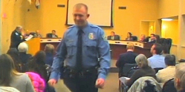 In this Feb. 11, 2014 image from video released by the City of Ferguson, Mo., officer Darren Wilson attends a city council m