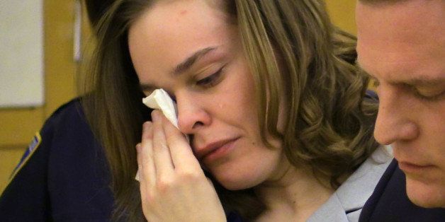 Defendant Lacey Spears wipes tears from her eyes as the prosecutor addresses the court during the opening statements portion of her murder trial at the Westchester County Courthouse in White Plains, N.Y., Tuesday, Feb. 3, 2015. She is accused of killing her 5 year old son by feeding him salt through a stomach tube. At right is one of her attorneys David. R. Sachs. (AP Photo/The Journal News, Joe Larese, Pool)