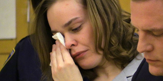 Defendant Lacey Spears wipes tears from her eyes as the prosecutor addresses the court during the opening statements portion of her murder trial at the Westchester County Courthouse in White Plains, N.Y., Tuesday, Feb. 3, 2015. She is accused of killing her 5 year old son by feeding him salt through a stomach tube. At right is one of her attorneys David. R. Sachs. (AP Photo/The Journal News, Joe Larese, Pool)