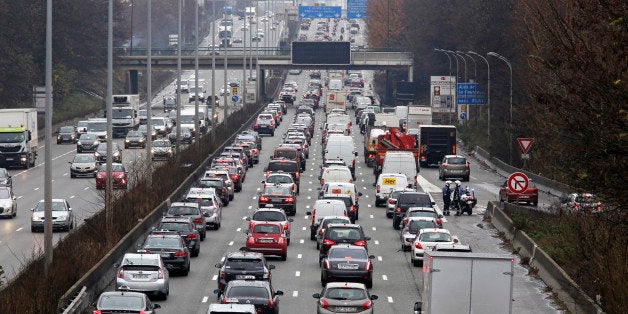 Taxis block and slow down traffic on the northern highway leading to Paris, Monday Dec. 15, 2014. Several hundred taxis blocked the roads heading from the Roissy Charles de Gaulle airport, then inched toward the French capital in their latest protest of the ride-sharing company. (AP Photo/Remy de la Mauviniere)