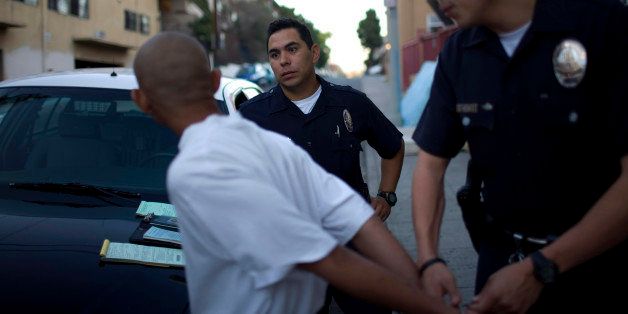 LOS ANGELES - SEPTEMBER 14: Los Angeles Police Department gang unit officers question a confirmed MS-13 street gang member September 14, 2007 in the Rampart area of Los Angeles, California. The gang member was ticketed for violating an injunction prohibiting public gatherings of two or more suspected or known gang members. MS-13, or Mara Salvatrucha 13, a street gang originally started in Los Angeles by refugees from El Salvador fleeing the civil war in the 1980's, has members in 33 US states. The LAPD gang unit is part of the Rampart police precinct where MS-13 and Hispanic street gangs have plagued local neighborhoods for decades. (Photo by Robert Nickelsberg/Getty Images)