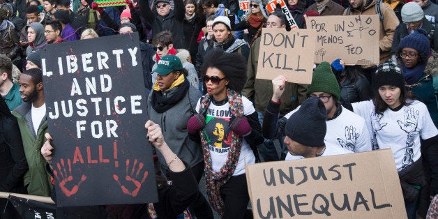 Demonstrators march in New York, Saturday, Dec. 13, 2014, during the Justice for All rally and march. In the past three weeks, grand juries have decided not to indict officers in the chokehold death of Eric Garner in New York and the fatal shooting of Michael Brown in Ferguson, Mo. The decisions have unleashed demonstrations and questions about police conduct and whether local prosecutors are the best choice for investigating police. (AP Photo/John Minchillo)