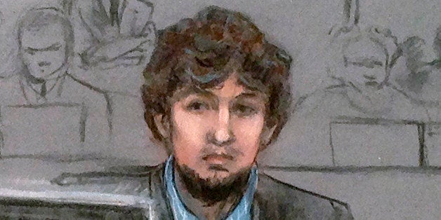 In this courtroom sketch, Dzhokhar Tsarnaev, right, and defense attorney Judy Clarke are depicted watching evidence displayed