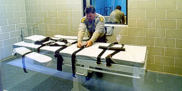 FILE - In this undated file photo provided by the Arizona Department of Corrections, an unidentified Arizona Corrections Officer adjusts the straps on the gurney used for lethal injections at the Arizona State Prison at Florence, Ariz. The prolonged execution this week of an Arizona death row inmate with a new, two-drug combination highlights the patchwork approach states have been forced to take with lethal injection drugs, with the types, combinations and dosages varying widely. (AP Photo/Arizona Department of Corrections)