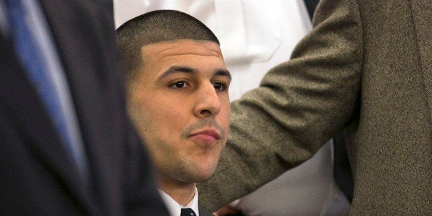Former New England Patriots football player Aaron Hernandez listens as the guilty verdict is read during his murder trial at