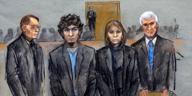 In this courtroom sketch, Dzhokhar Tsarnaev, second from left, is depicted standing with his defense attorneys William Fick,