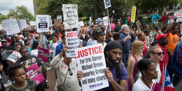 FILE - Demonstrators march to protest the death of Eric Garner, Saturday, Aug. 23, 2014, in the Staten Island borough of New York. Amid the fallout from a grand jury's decision in the fatal police shooting of Michael Brown in Missouri, a panel in New York City is quietly nearing its own conclusion about another combustible case involving the death of an unarmed man at the hands of police. (AP Photo/John Minchillo, File)