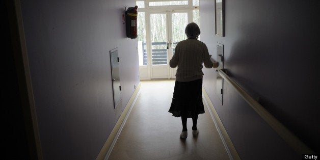 A woman, suffering from Alzheimer's desease, walks in a corridor on March 18, 2011 in a retirement house in Angervilliers, eastern France. AFP PHOTO / SEBASTIEN BOZON (Photo credit should read SEBASTIEN BOZON/AFP/Getty Images)