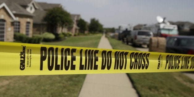 Crime scene tape marks off the area law enforcement investigators are working outside the house of a fatal shooting Thursday morning, Aug. 8, 2013, in DeSoto, Texas. A man has been arrested in the fatal shooting of four people in two Dallas-area homes, just minutes apart, and police are investigating if he used a grenade or other explosive in one of the attacks. Investigators arrested Erbie Bowser, 44, on Wednesday night at the second crime scene, DeSoto police Cpl. Melissa Franks said. Charges are pending, she said. (AP Photo/LM Otero)