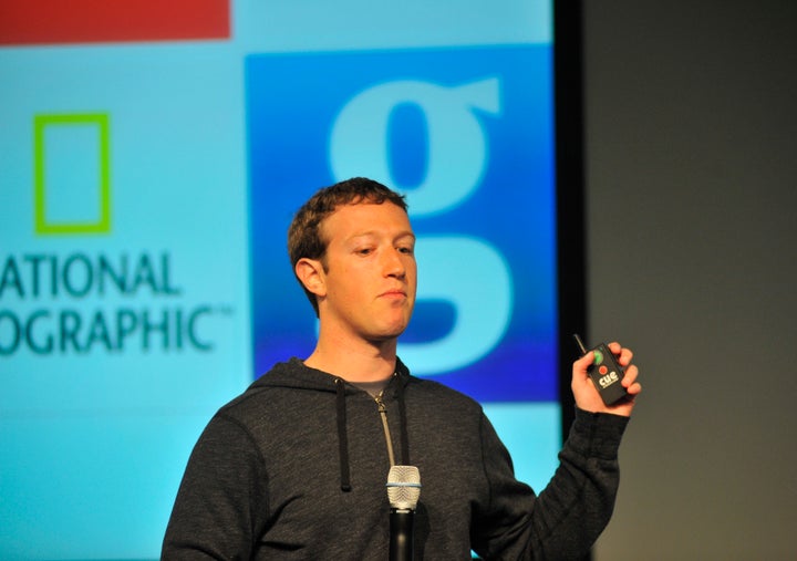 Facebook CEO Mark Zuckerberg controls a slide show as he speaks during a media event at Facebook's Headquarters office in Menlo Park, California on March 7, 2013. Today, Facebook announced updates to their News Feed. AFP PHOTO /Josh EDELSON (Photo credit should read Josh Edelson/AFP/Getty Images)