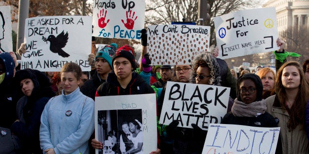 Demonstrators march on Pennsylvania Avenue toward Capitol Hill in Washington, Saturday, Dec. 13, 2014, during the Justice for All rally. More than 10,000 protesters are converging on Washington in an effort to bring attention to the deaths of unarmed black men at the hands of police. Civil rights organizations are holding a march to the Capitol on Saturday with the families of Michael Brown and Eric Garner, two unarmed black men who died in incidents with white police officers. (AP Photo/Jose Luis Magana)