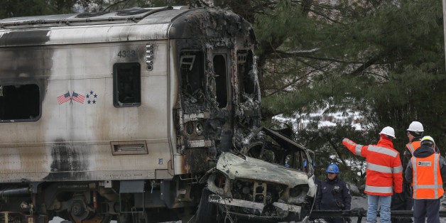 VALHALLA, NY - FEBRUARY 04: Officials inspect a Metro-North train crash with a sport utility vehicle that occurred last night